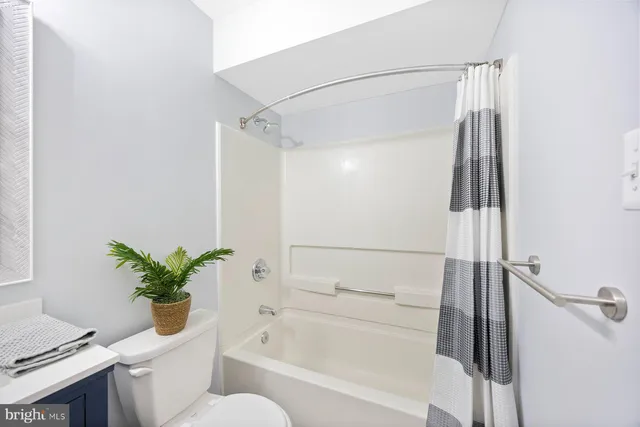 a bathroom with a shower curtain and a sink