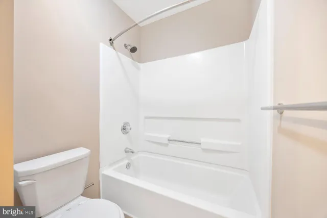 a bathroom with a toilet and a bathtub