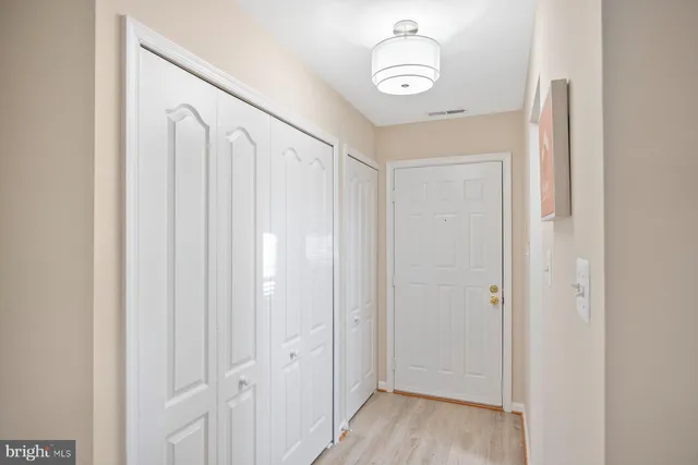a view of a hallway with wooden floor