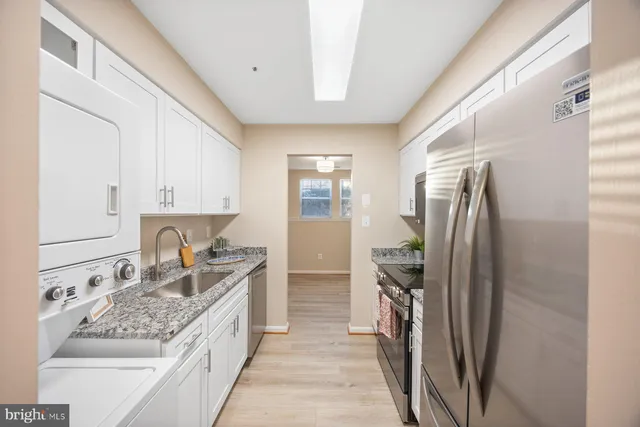 a kitchen with a sink stove and refrigerator