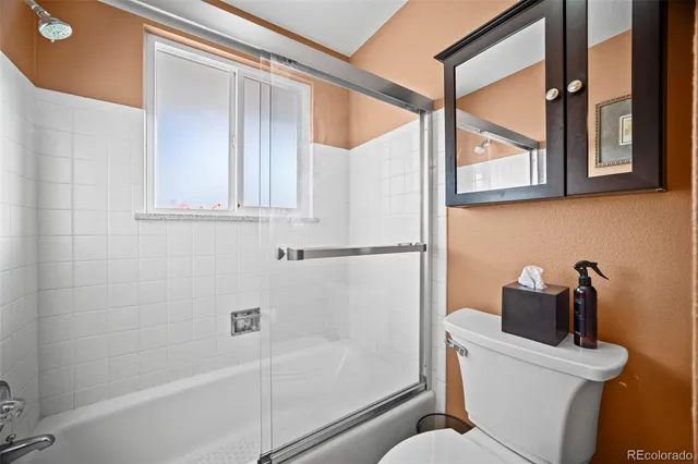 a bathroom with a shower a toilet and a sink