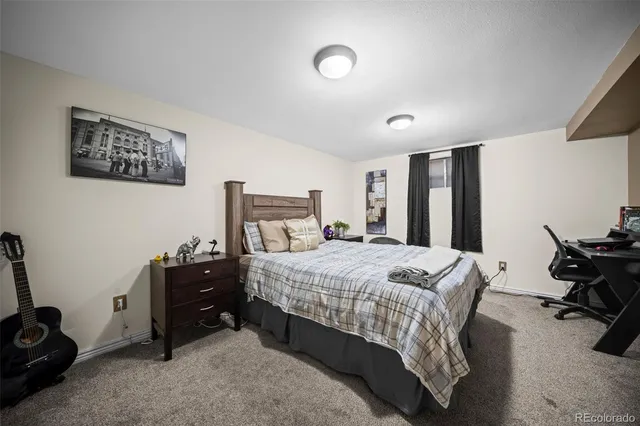 a bedroom with a bed and a chair