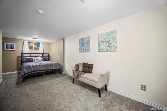 a bedroom with a bed and a couch