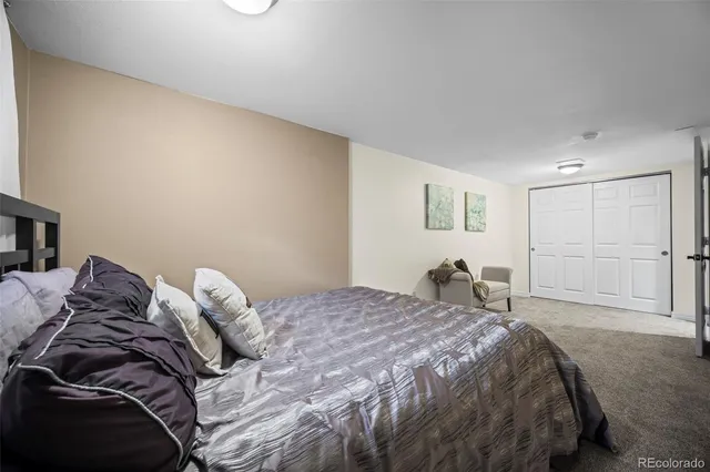 a bed sitting in a bedroom and closet