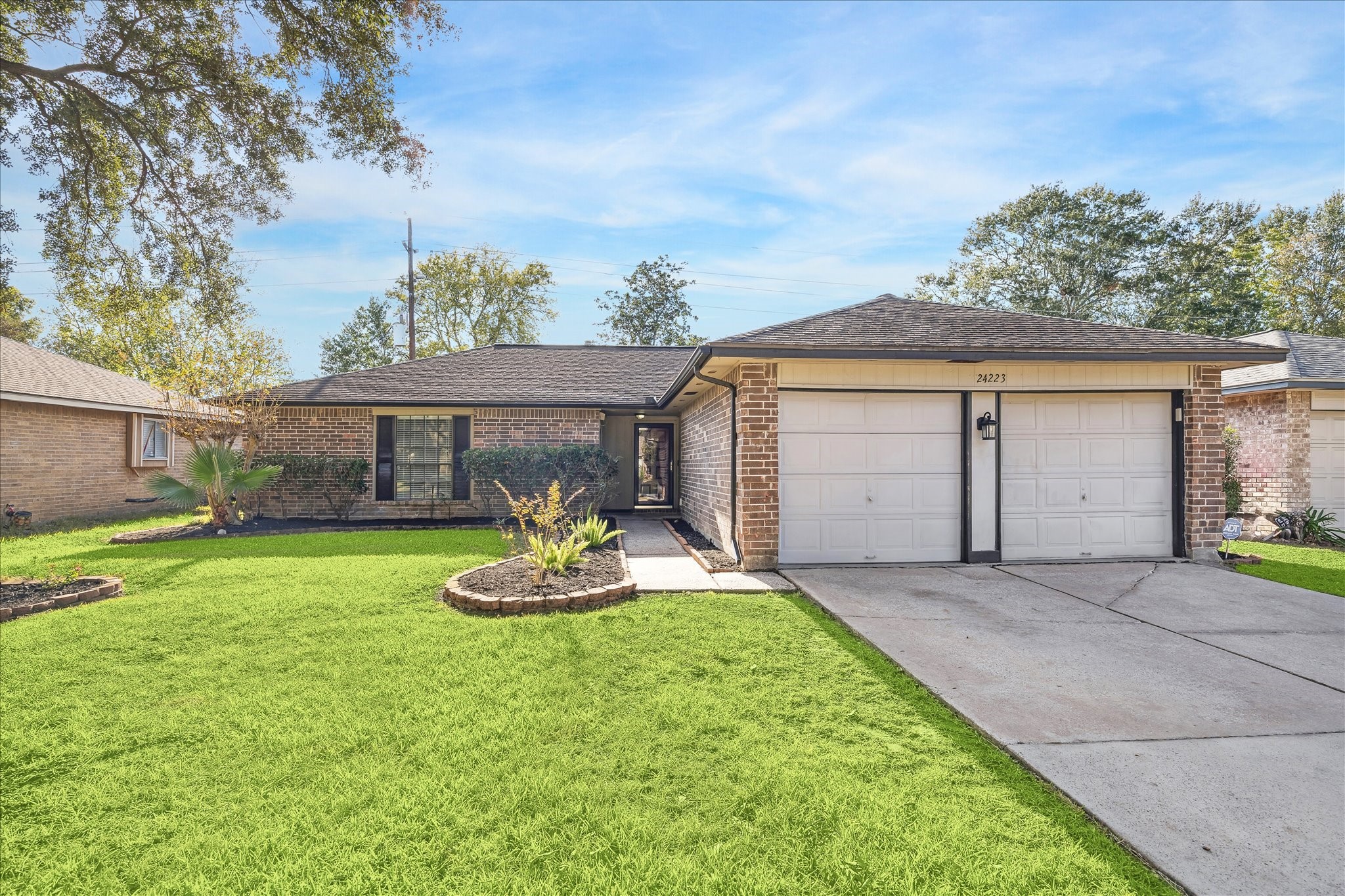 a front view of house with a garden and patio