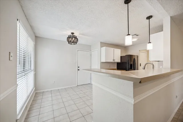 a view of a kitchen with electric appliances