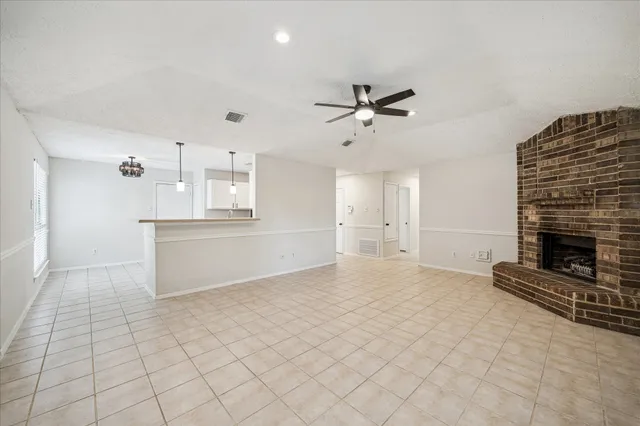 a view of a kitchen with wooden cabinet and a fireplace