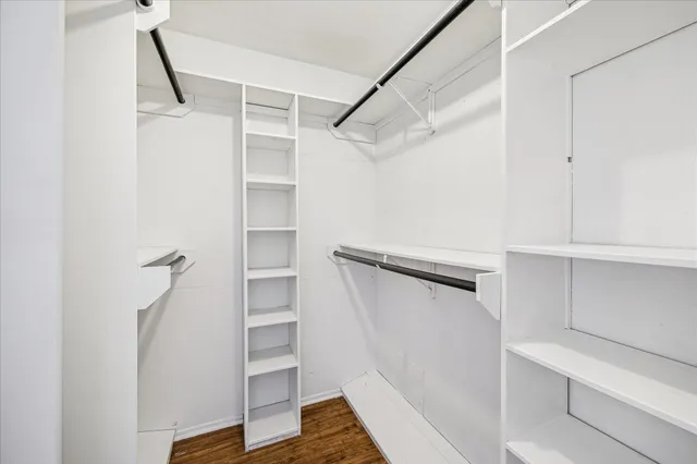 a view of walk in closet with empty racks