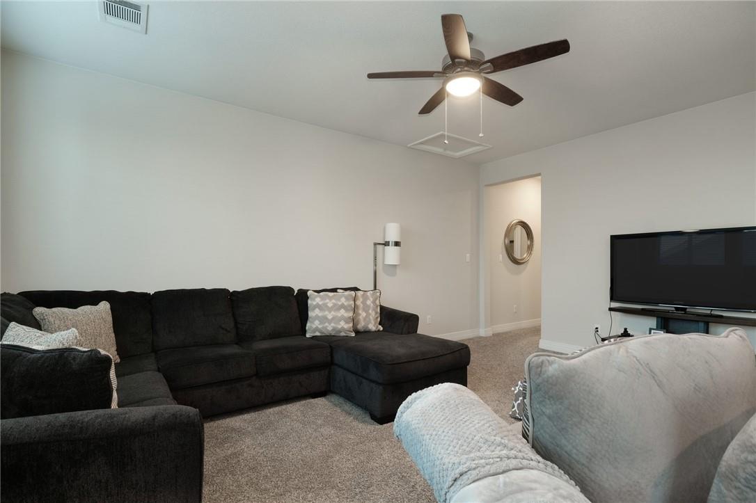 229 Bonnet Boulevard Georgetown, TX 78628 - Photo 14 of 20 Carpeted living area with ceiling fan and baseboards
