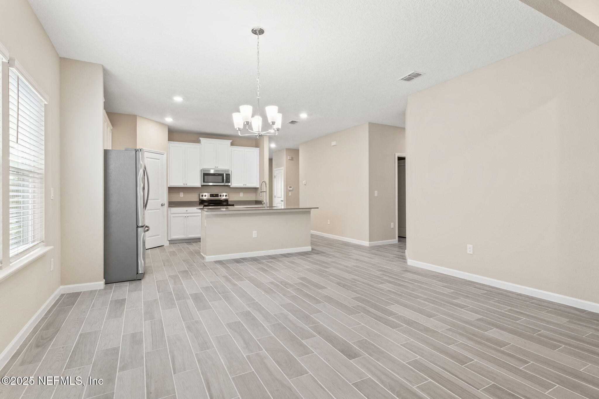911 Colon Lane Jacksonville, FL 32218 - Photo 12 of 32 a view of a kitchen with a sink and dishwasher a refrigerator with wooden floor