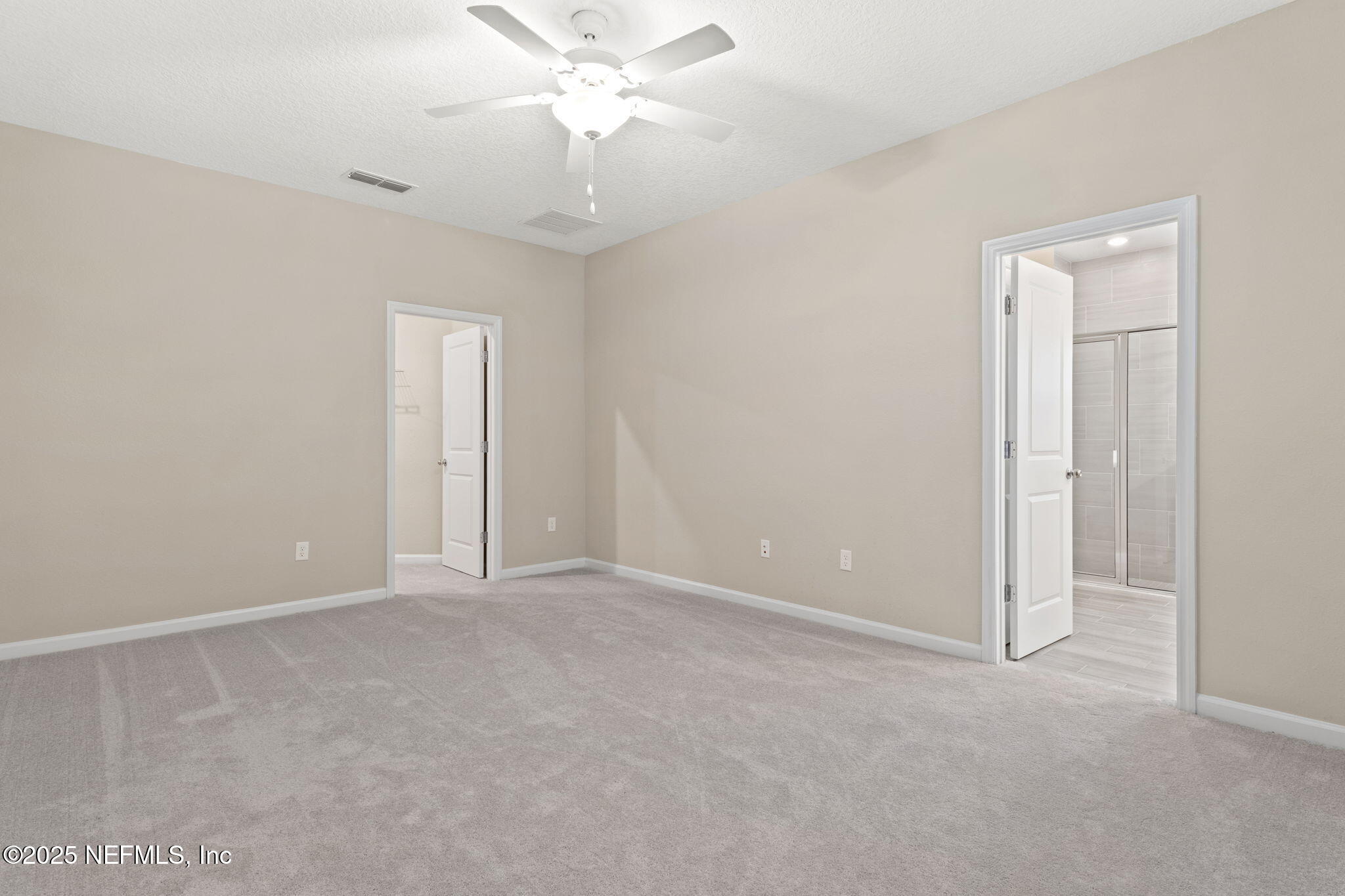 911 Colon Lane Jacksonville, FL 32218 - Photo 13 of 32 an empty room with a chandelier fan and windows