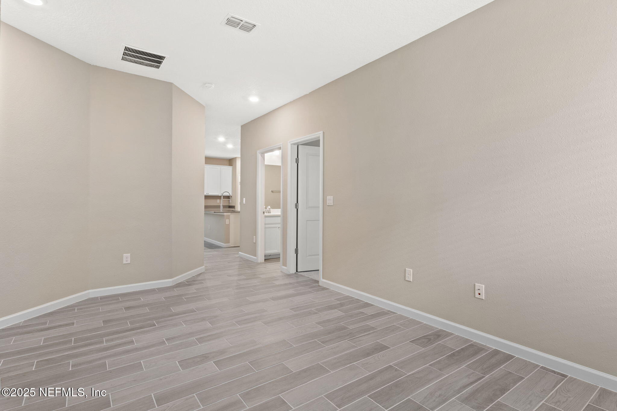 911 Colon Lane Jacksonville, FL 32218 - Photo 18 of 32 a view of an empty room with wooden floor and a window