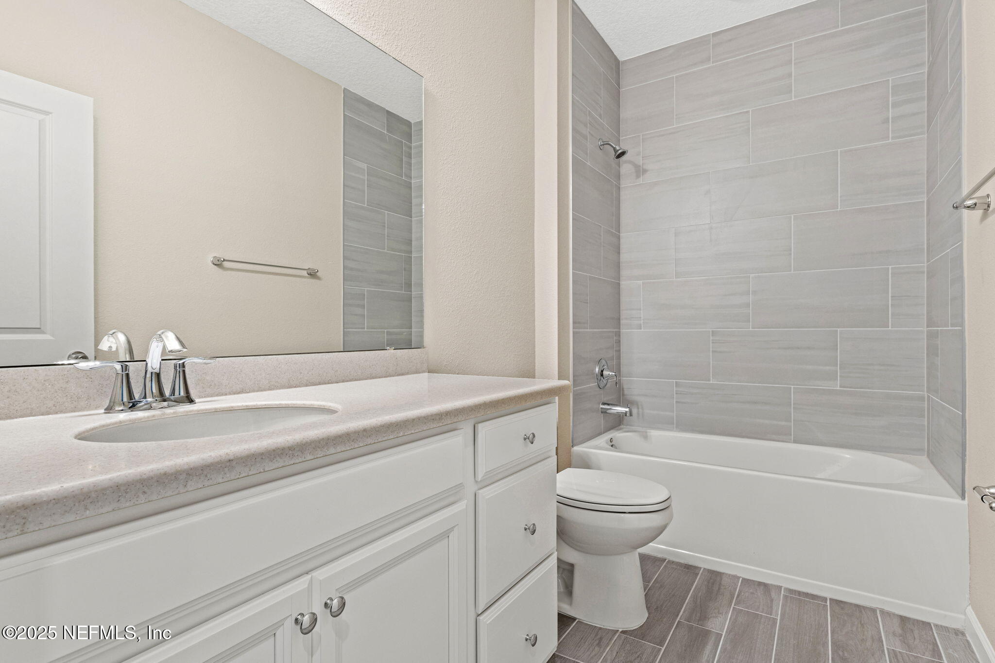 911 Colon Lane Jacksonville, FL 32218 - Photo 25 of 32 a bathroom with a granite countertop sink a toilet and a bathtub