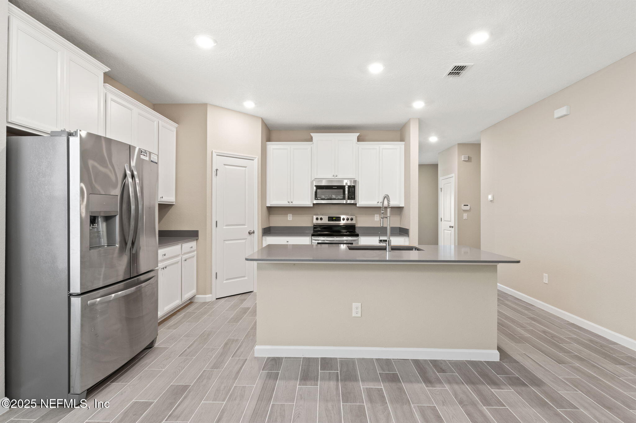 911 Colon Lane Jacksonville, FL 32218 - Photo 6 of 32 a kitchen with stainless steel appliances a refrigerator and a stove top oven