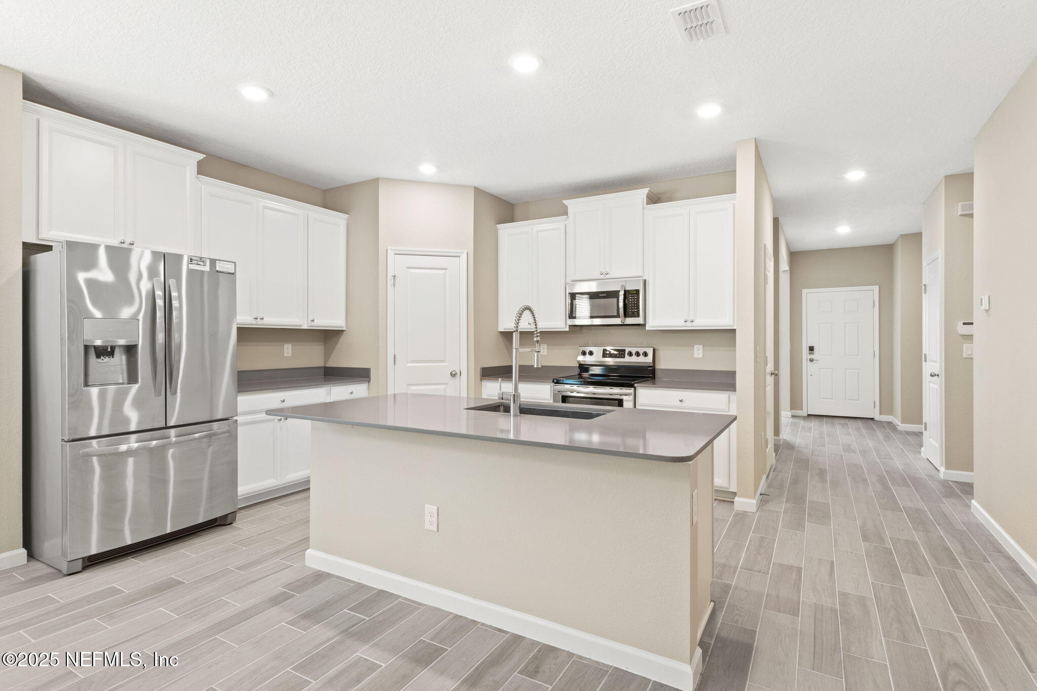911 Colon Lane Jacksonville, FL 32218 - Photo 7 of 32 a kitchen with stainless steel appliances granite countertop a refrigerator sink and microwave