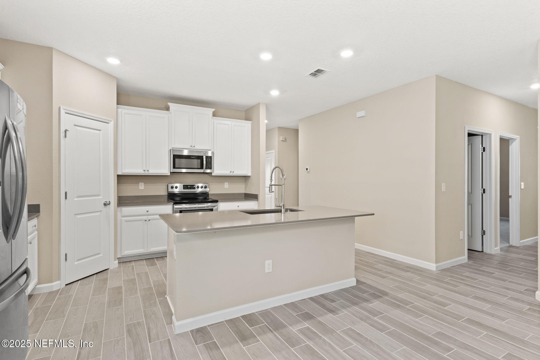 911 Colon Lane Jacksonville, FL 32218 - Photo 8 of 32 a kitchen with stainless steel appliances granite countertop a stove a sink and a refrigerator