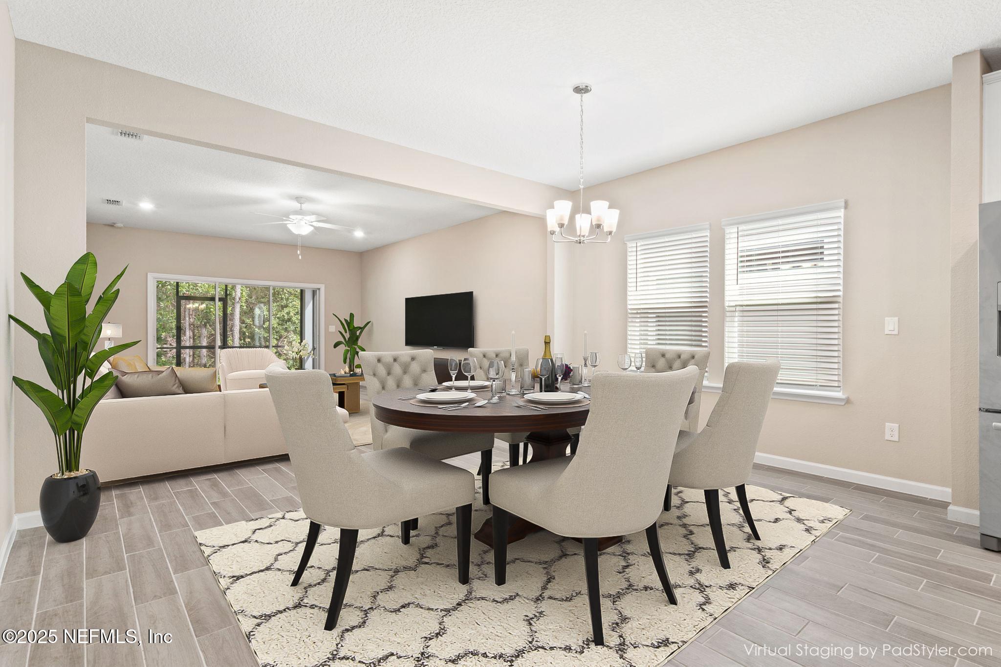 911 Colon Lane Jacksonville, FL 32218 - Photo 10 of 32 a view of a dining room with furniture and chandelier