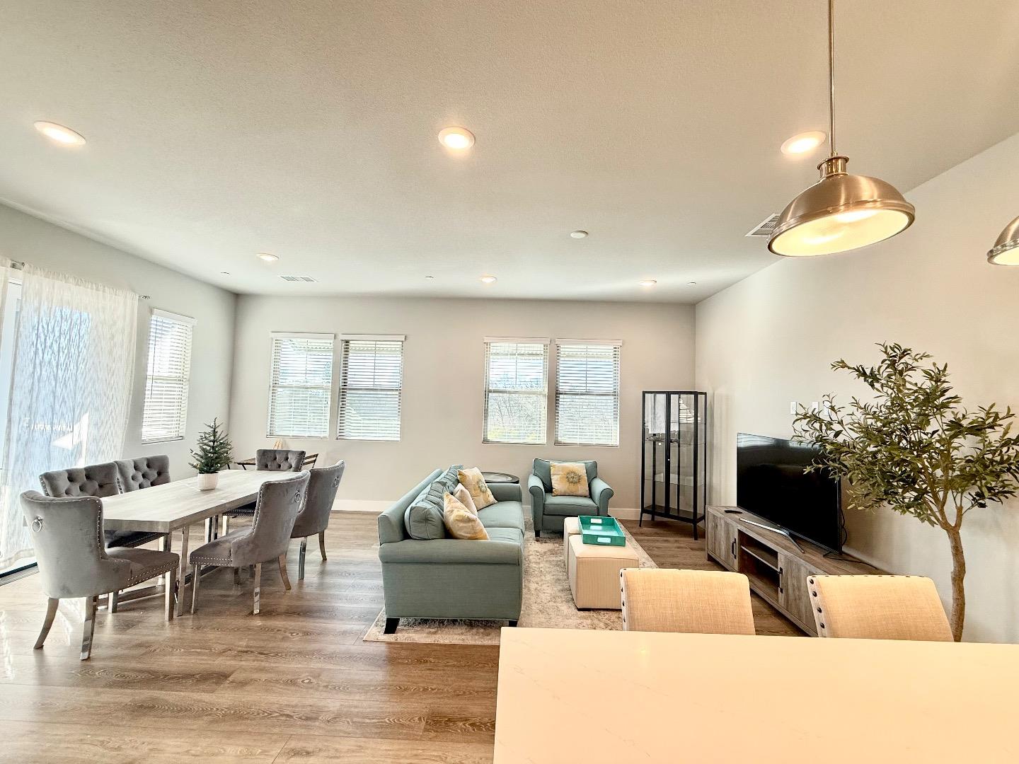 1661 Spring Street, Unit 424 Davis, CA 95616 - Photo 1 of 34 a living room with furniture and a potted plant