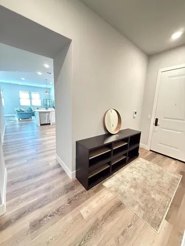 a view of room with wooden floor