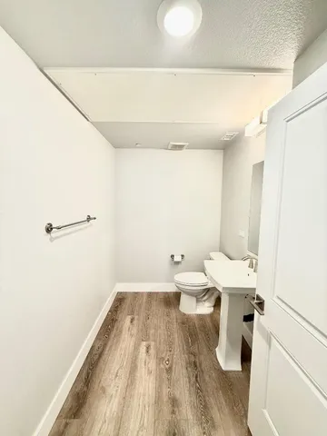 a bathroom with a sink a toilet and a mirror