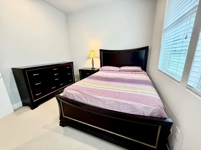 a bedroom with a bed and a dresser