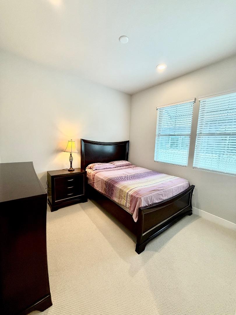 1661 Spring Street, Unit 424 Davis, CA 95616 - Photo 15 of 34 a bedroom with a bed and wooden floor