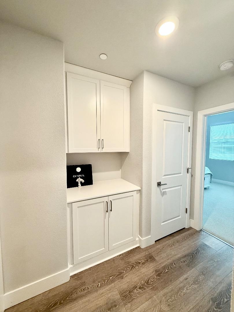1661 Spring Street, Unit 424 Davis, CA 95616 - Photo 18 of 34 a view of a kitchen with white cabinets and wooden floor