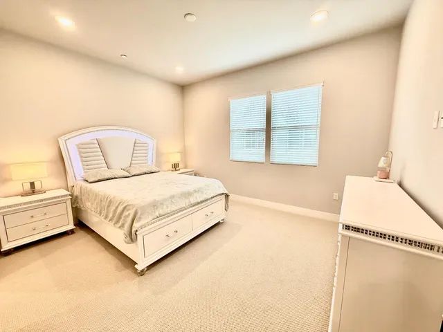 a bedroom with a large bed and a window