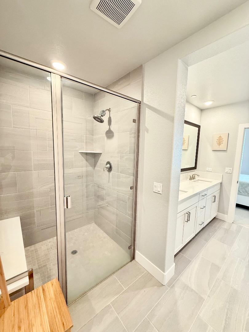 1661 Spring Street, Unit 424 Davis, CA 95616 - Photo 25 of 34 a bathroom with a double vanity sink mirror and shower