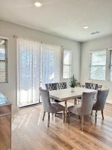 a view of a dining room with furniture and window