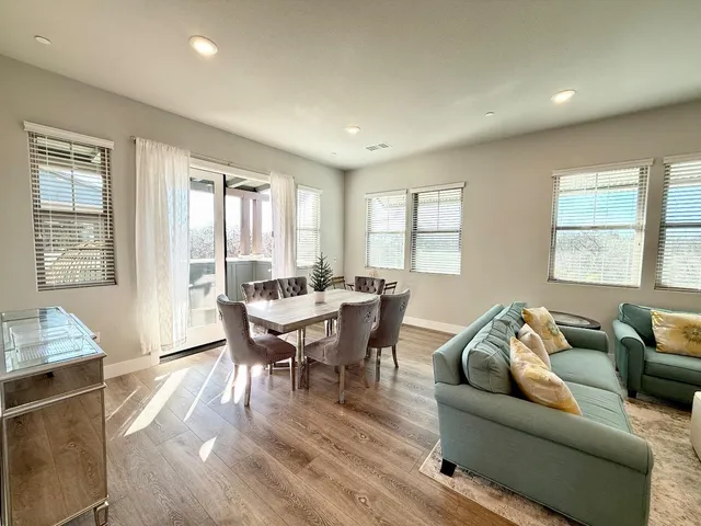 a living room with furniture wooden floor and a window