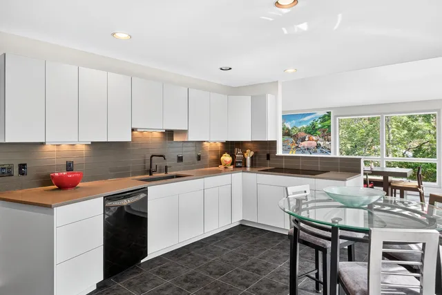 a kitchen with a sink cabinets and window