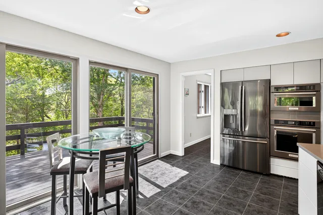 a kitchen with a table and refrigerator