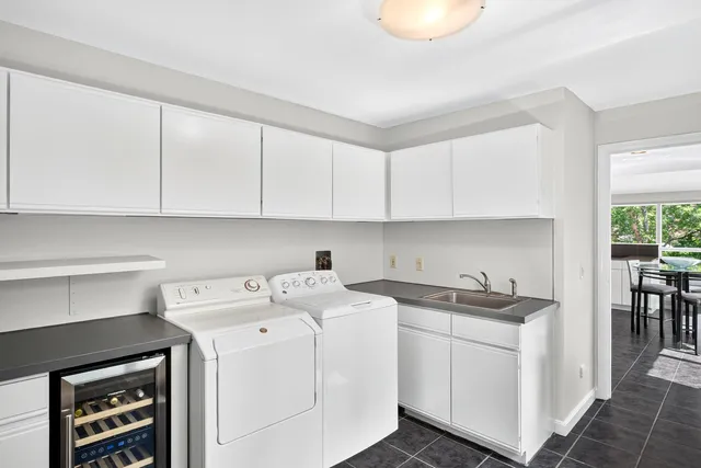 a utility room with sink dryer and washer