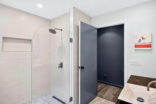a bathroom with a shower and a sink