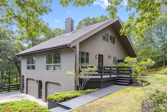 a view of a house with backyard and sitting area