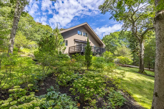 a view of a house with a tree in a yard