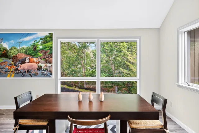 a view of a dining room with furniture and a window