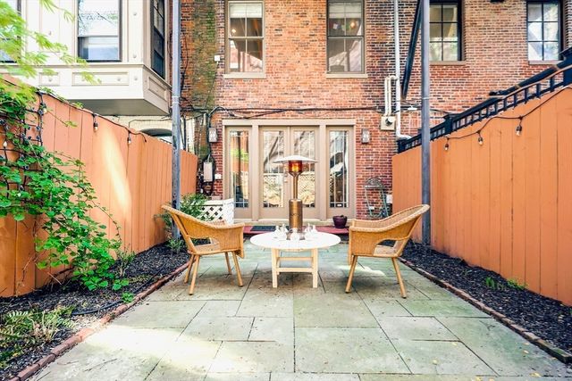 a backyard of a house with outdoor seating
