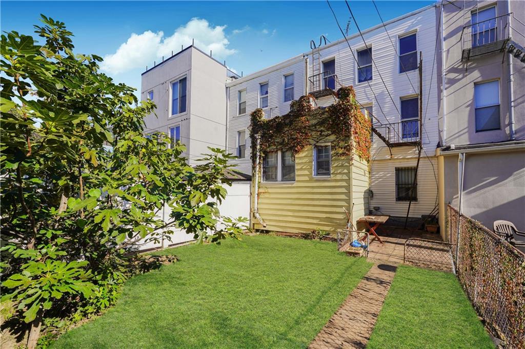 1122 39th Street Brooklyn, NY 11218 - Photo 14 of 27 a view of a house with a small yard and plants