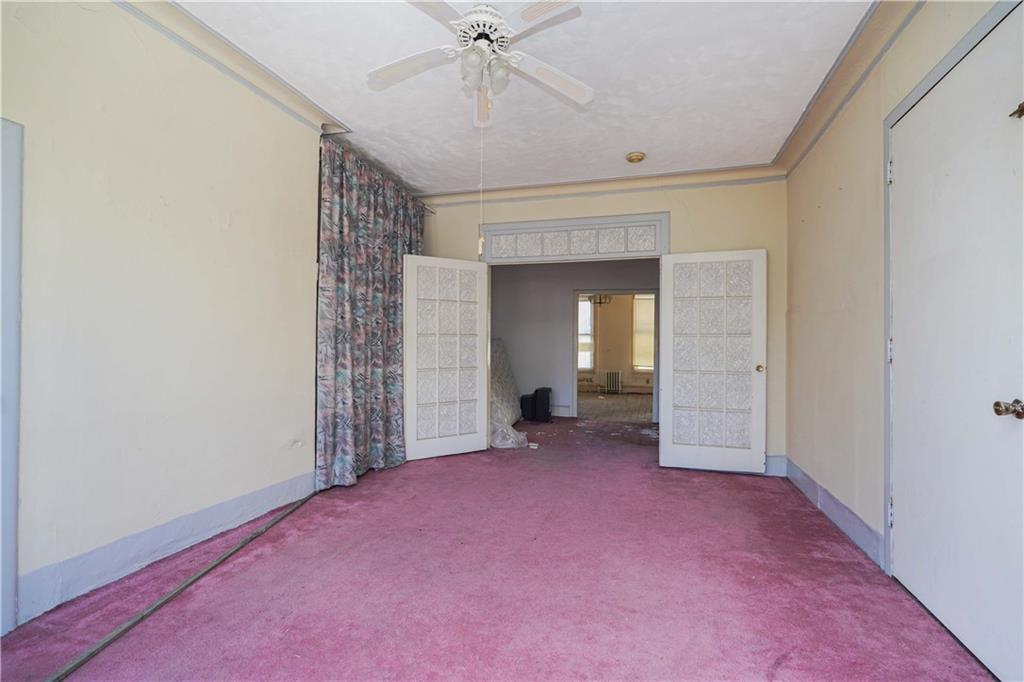 1122 39th Street Brooklyn, NY 11218 - Photo 7 of 27 a view of a livingroom with a ceiling fan and window