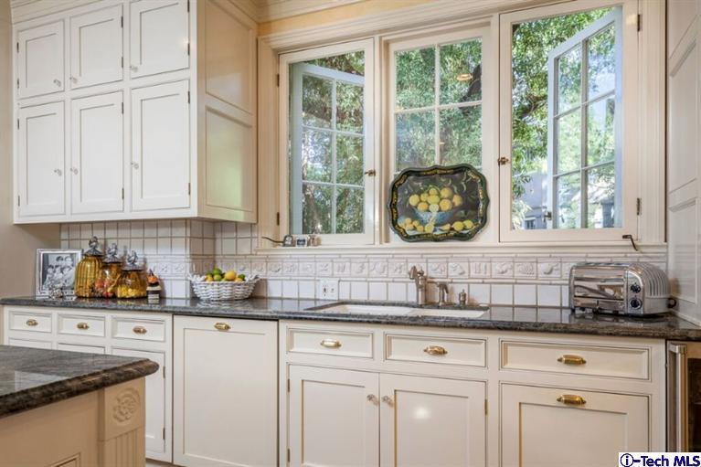 445 Prospect Square Pasadena, CA 91103 - Photo 16 of 45 a kitchen with granite countertop a sink window and cabinets