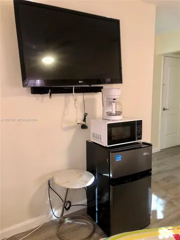 a kitchen with a sink a stove and chairs