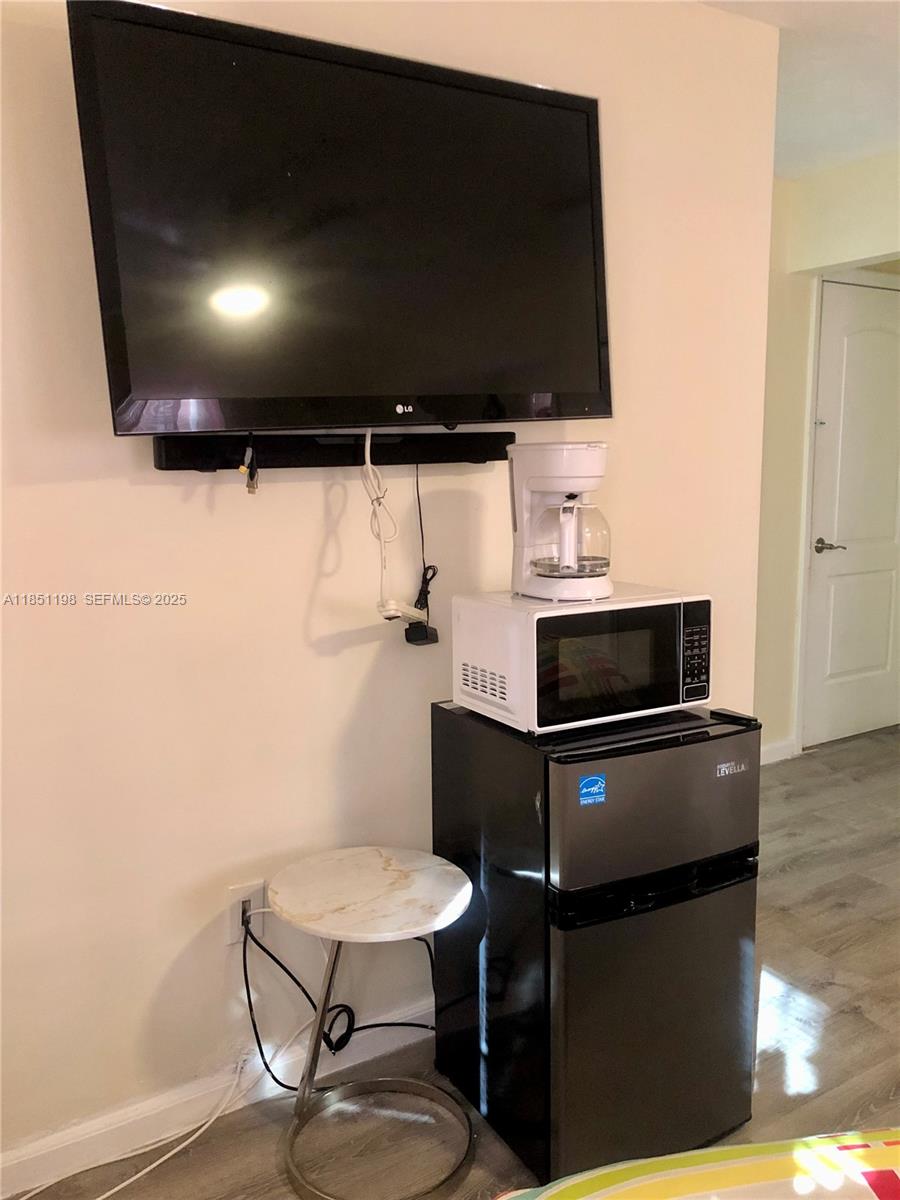 6890 Liberty Street Hollywood, FL 33024 - Photo 4 of 12 a kitchen with a sink a stove and chairs