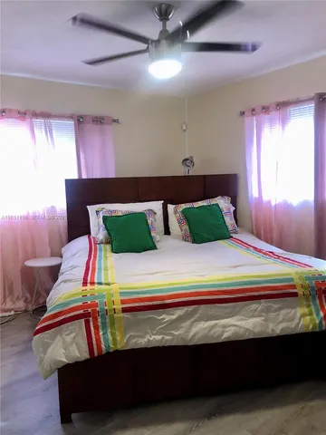 a bedroom with a bed and window