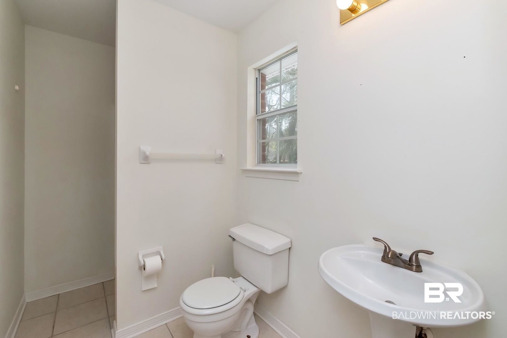 10006 Wedgefield Court Mobile, AL 36608 - Photo 27 of 34 Bathroom featuring tile patterned flooring, baseboards, a sink, and toilet