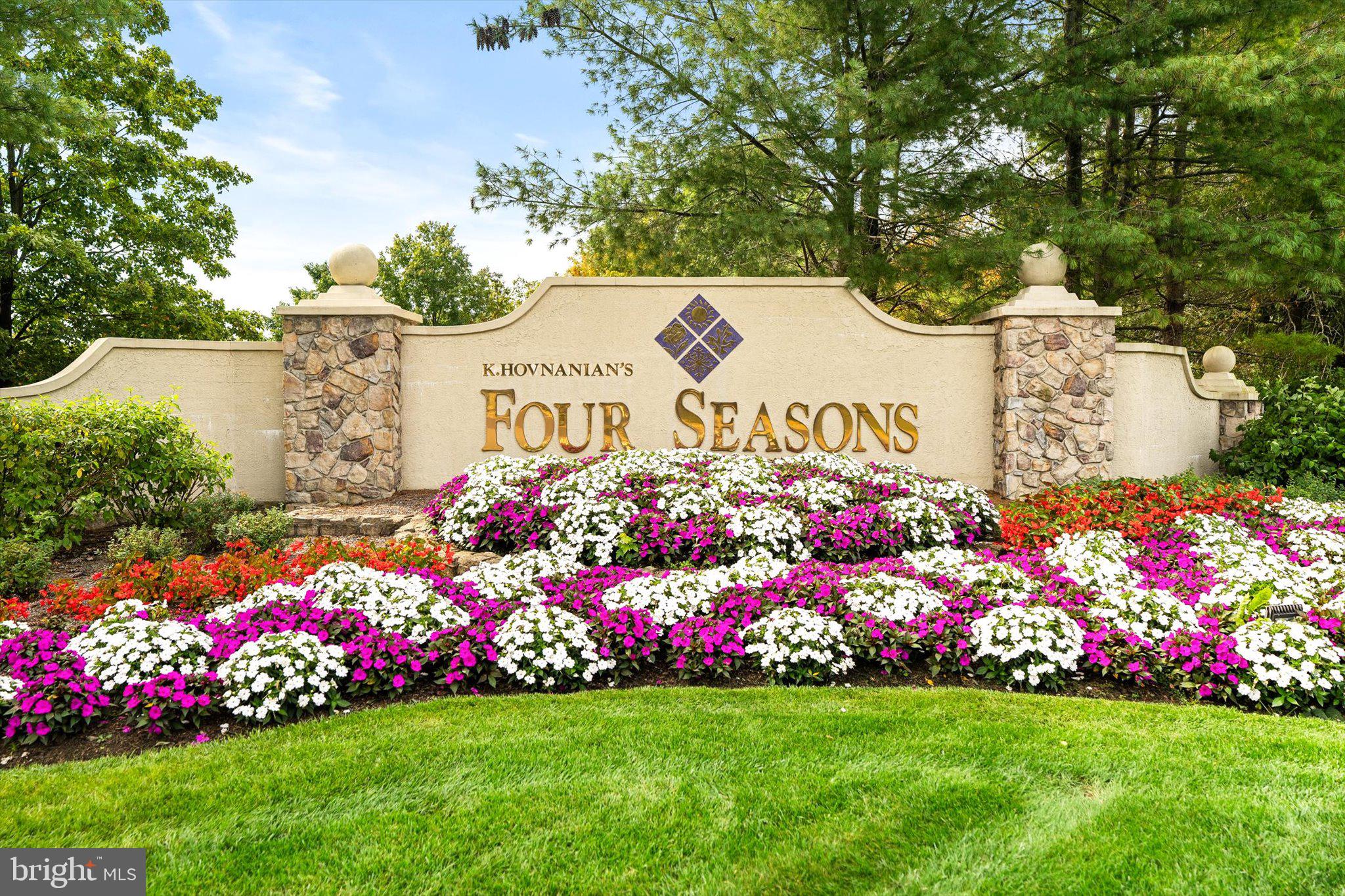a street sign is sitting in front of flowers