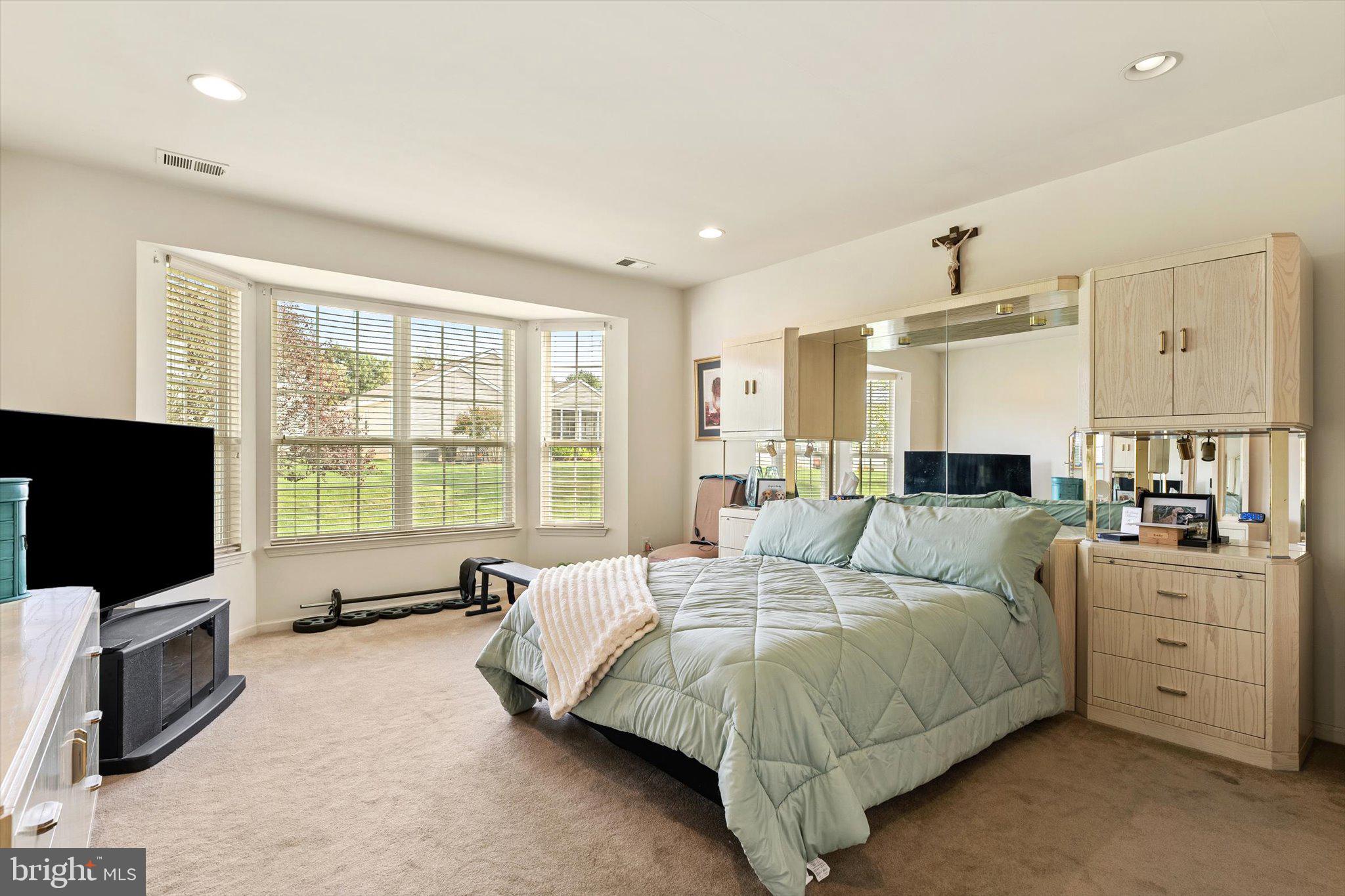 87 Chamber Lane Columbus, NJ 08022 - Photo 15 of 42 a spacious bedroom with a bed and a flat screen television