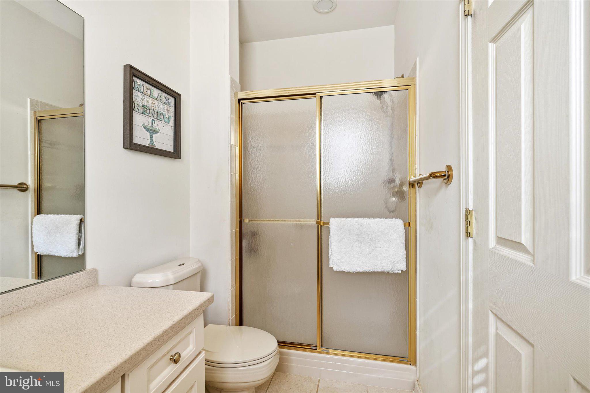 87 Chamber Lane Columbus, NJ 08022 - Photo 18 of 42 a bathroom with a granite countertop toilet and a shower