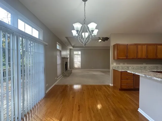 a view of a kitchen with wooden floor and a sink